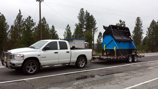 Hauling a topsoil screener rental to the job site